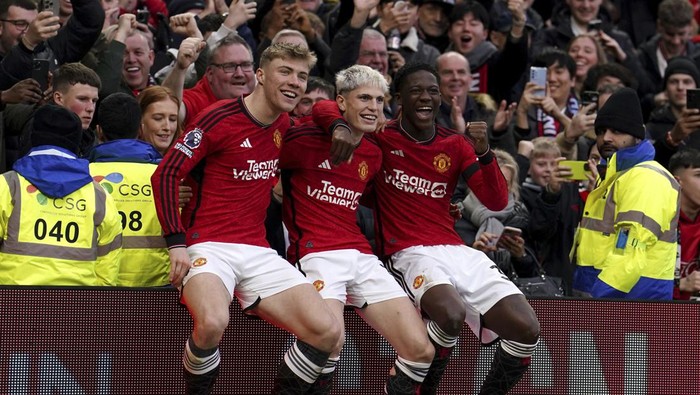 Manchester Uniteds Alejandro Garnacho, centre, celebrates with Rasmus Hojlund, left, and Kobbie Mainoo after scoring their sides second goal of the game during the Premier League match between Manchester United and West Ham United at Old Trafford, Manchester, England, Sunday Feb. 4, 2024. (Martin Rickett/PA via AP)
