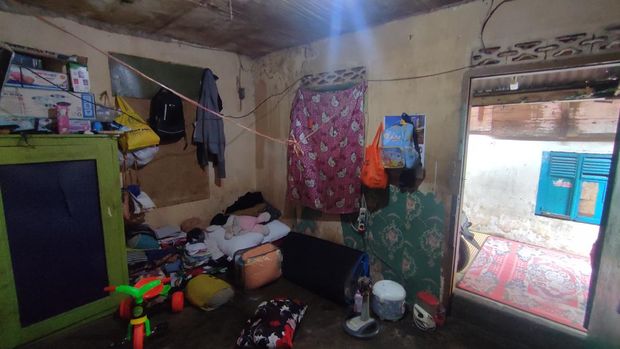 Ruang tengah kontrakan rumah Iki yang penuh dengan barang.
