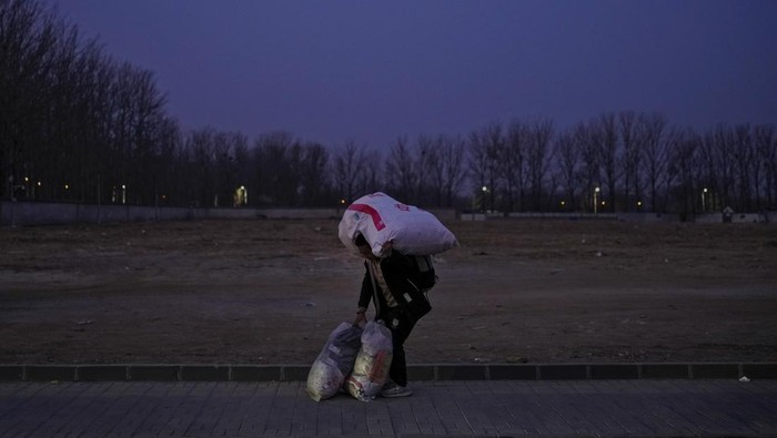 Potret Ribuan Kendaraan Terjebak Macet saat Mudik Imlek di China A migrant worker carrying his belonging leaves a village to catch his transport on the outskirt of Beijing, Tuesday, Feb. 6, 2024. Widespread snowfall and freezing weather continued in central and eastern China disrupting transport and stranding travelers amid the annual Lunar New Year travel rush. (AP Photo/Andy Wong)