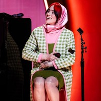 Billie Eilish mengenakan gaun turtle neck berbahan rajut yang dipadu cardigan panjang motif gingham berwarna hijau-pink. Foto: FilmMagic/Timothy Norris