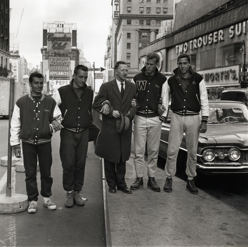 Dr. Walter Hendricks (center), president of Windham College in Putney, Vermont, stands between the four Windham students who arrived in Times Square after a 220-mile hike from the college. The students, who walked in support of President John F Kennedy's physical fitness program, are (from left to right) Frank Catapano, Bruce Blassius, Anthony Broom, and Richard Murphy.