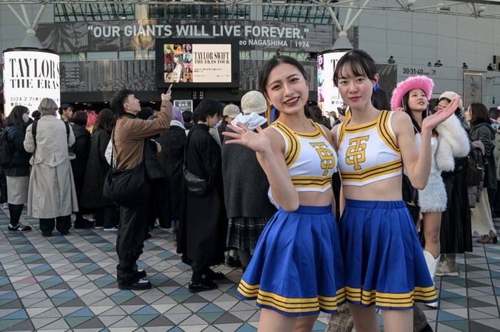 Fans of US singer Taylor Swift, also known as Swifties, pose for photos outside the Tokyo Dome shortly before the start of the first leg of her Asia-Pacific 