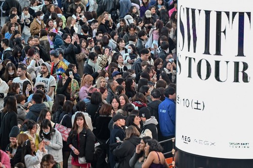 Fans of US singer Taylor Swift, also known as Swifties, queue to enter the Tokyo Dome shortly before the start of the first leg of her Asia-Pacific 