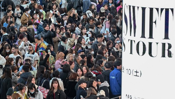 Fans of US singer Taylor Swift, also known as Swifties, queue to enter the Tokyo Dome shortly before the start of the first leg of her Asia-Pacific 