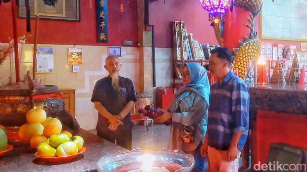 Amsah dan suami saat melakukan ritual ciam si perayan tahun baru imlek di Klenteng Bio Kwan Tee Koen Karawang