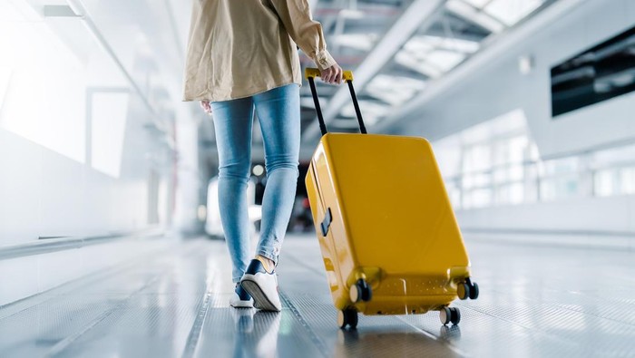 International airport terminal. Asian beautiful woman with luggage and walking in airport