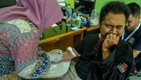 Ekspresi salah satu petugas KPU saat disuntik.