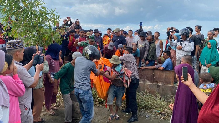 Polisi dan warga mengevakuasi mayat korban hilang di Sungai Batang Merao, Kerinci.