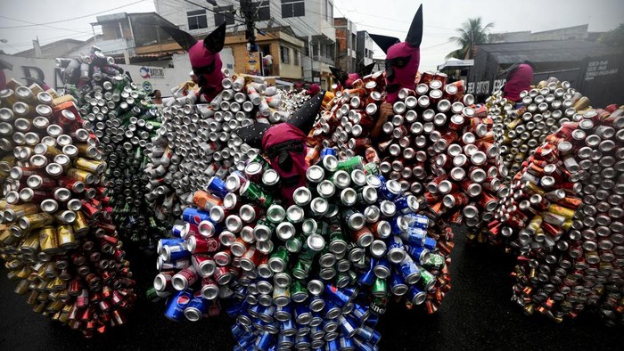 Revelers wearing costumes made from beer and soda cans take part in the 'Bloco da Latinha' street party Carnival parade in Madre de Deus, Brazil, Sunday, Feb. 11, 2024. (AP Photo/Eraldo Peres)
