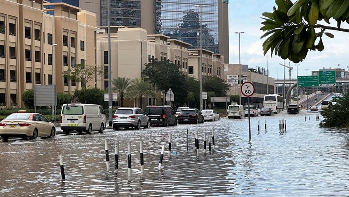Cars drive through a flooded street in the aftermath of a heavy rainstorm, in Dubai, United Arab Emirates, February 12, 2024. REUTERS/Abdel Hadi Ramahi