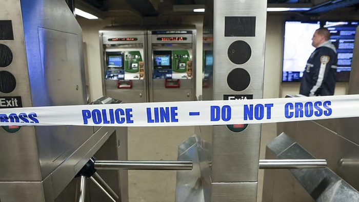 New York Police walk through the Mount Eden subway station while investigating a shooting, Monday, Feb. 12, 2024, in the Bronx borough of New York. Several people were shot Monday at the New York City subway station, police said. (New York Police Department via AP)