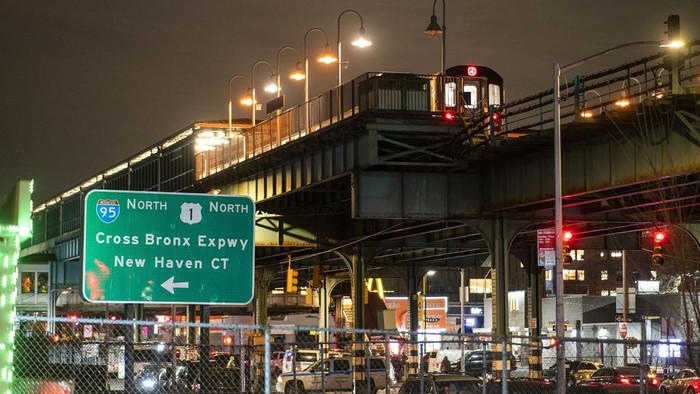 A subway train remains in investigation by police officers after a shooting at the Mount Eden Avenue subway station, Monday, Feb. 12, 2024, in the Bronx borough of New York. (AP Photo/Eduardo Munoz Alvarez)