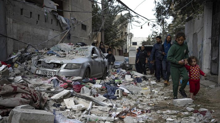 Palestinians look at the destruction after an Israeli airstrike in Rafah, Gaza Strip, Friday, Feb. 9, 2024. (AP Photo/Fatima Shbair)