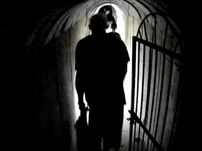 This image grab from a handout video released by the Israeli army on February 13, 2024, shows what the army says is Hamass chief in Gaza Yahya Sinwar walking in a tunnel along with other people, in the Gaza Strip amid ongoing battles between Israel and the Palestinian militant group Hamas. Israels army released a video it said was of Sinwar, filmed on October 10, 2023 with his family members in a tunnel in the Palestinian territory. The black and white images showing a man said to be the Hamas chief being led through a tunnel together with a woman and three children are said to be the first of him since the Israel-Hamas war broke out. (Photo by Israeli Army / AFP) / === RESTRICTED TO EDITORIAL USE - MANDATORY CREDIT 