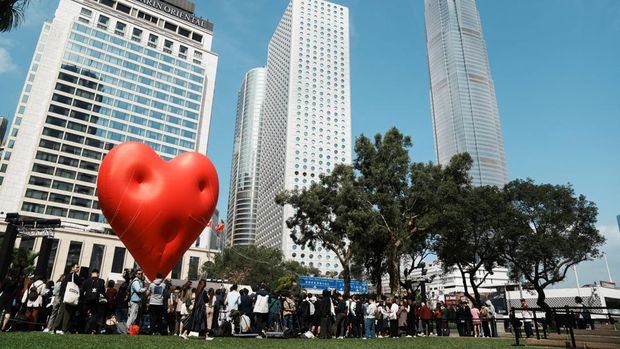 Visitors pose for pictures with a giant inflatable heart called 