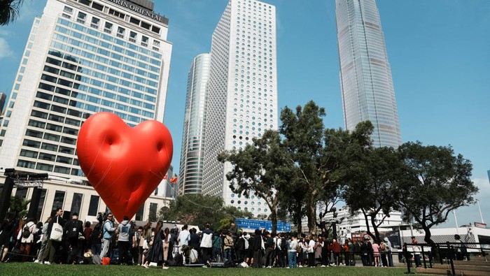 VALENTINES-DAY/HONGKONG Visitors pose for pictures with a giant inflatable heart called