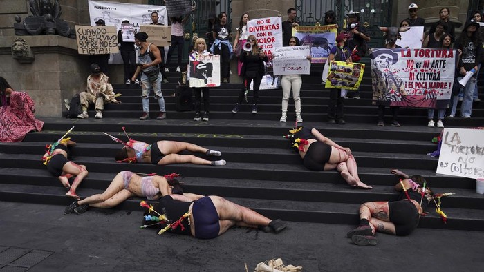 Animal rights activists smeared with fake blood and donning banderillas to depict bulls stabbed in bullfights, protest against bullfighting, in Mexico City, Wednesday, Feb. 14, 2024. The debate over the reopening of Mexico City's bullring has been intensifying in recent weeks as a new initiative is being submitted to legislators to suspend the controversial practice. (AP Photo/Marco Ugarte)
