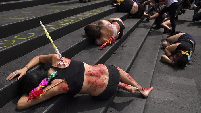 Animal rights activists smeared with fake blood and donning banderillas to depict bulls stabbed in bullfights, protest against bullfighting, in Mexico City, Wednesday, Feb. 14, 2024. The debate over the reopening of Mexico City's bullring has been intensifying in recent weeks as a new initiative is being submitted to legislators to suspend the controversial practice. (AP Photo/Marco Ugarte)