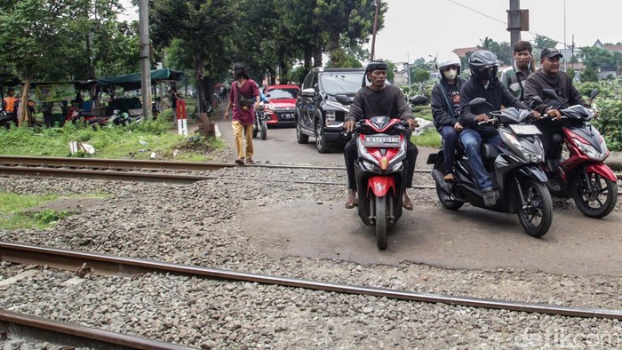 Hati-hati Melintas, Jalan di TPU Tanah Kusir Tak Ada Palang Pintu Jalan tembus di TPU Tanah Kusir, Jakarta masih belum memiliki palang pintu rel kereta. Pengendara dan pejalan kaki perlu berhati-hati saat melintas.