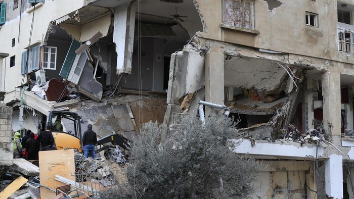 Civil defence and rescue workers remove rubbles from a building that was attacked Wednesday night by an Israeli airstrike, in Nabatiyeh town, south Lebanon, Thursday, Feb. 15, 2024. The airstrike killed and injured several people and child, Lebanon's state news agency reported. (AP Photo/Mohammed Zaatari)