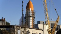 The Space Shuttle Endeavour is seen standing stacked with the fuel tanks at the site of the future Samuel Oschin Air and Space Center on Tuesday, Jan. 30, 2024, in Los Angeles. NASAs retired Space Shuttle Endeavour was carefully hoisted late Monday to be mated to a huge external fuel tank and its two solid rocket boosters at a Los Angeles museum where it will be uniquely displayed as if it is about to blast off. (AP Photo/Richard Vogel)