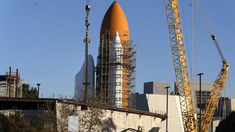 The Space Shuttle Endeavour is seen standing stacked with the fuel tanks at the site of the future Samuel Oschin Air and Space Center on Tuesday, Jan. 30, 2024, in Los Angeles. NASA's retired Space Shuttle Endeavour was carefully hoisted late Monday to be mated to a huge external fuel tank and its two solid rocket boosters at a Los Angeles museum where it will be uniquely displayed as if it is about to blast off. (AP Photo/Richard Vogel)