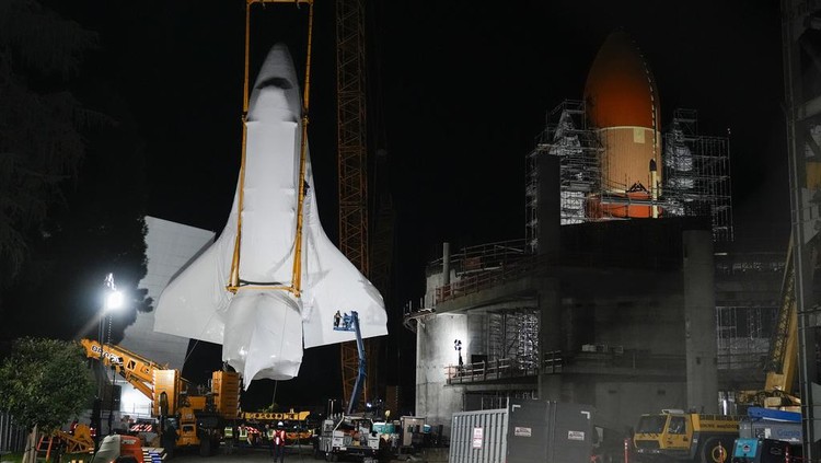 Space Shuttle Endeavour is lifted into the site of the future Samuel Oschin Air and Space Center on Monday, Jan. 29, 2024, in Los Angeles. (AP Photo/Ashley Landis)