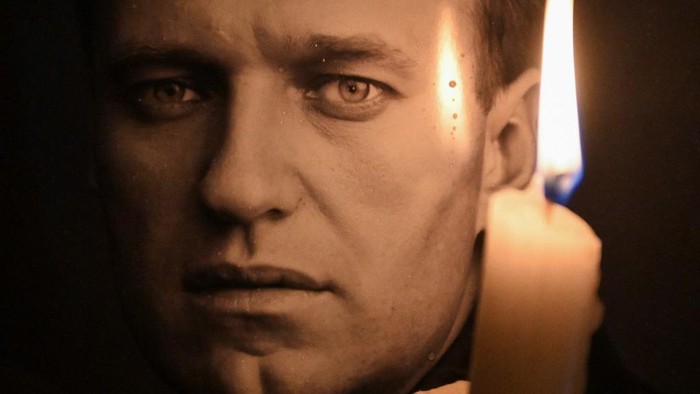 A man holds a candle and a photo of Russian opposition leader Alexei Navalny at a makeshift memorial as people demonstrate and pay their respect following his death in prison, in front of former Russian consulate  in Frankfurt, western Germany on February 16, 2024. Russian opposition leader Navalny died on February 16 at the Arctic prison colony in Russias Yamalo-Nenets region in northern Siberia where he was serving a 19-year-term. Russian authorities announced Navalnys death a month before an election poised to extend Russian President Putins hold on power. (Photo by AFP)