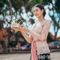 Mengenakan kebaya Bali, Anya juga tampak membawa canang sari, semacam sesajen yang biasa digunakan umat Hindu di Bali. Foto: Instagram/@anyageraldine