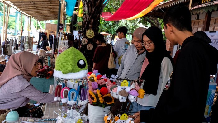 Pengunjung melihat produk kerajinan seni yang dipasarkan saat pameran UMKM di kawasan wisata Ngarsopuro, Solo, Jawa Tengah, Minggu (18/2/2024). Pameran bertajuk Solo Art Market yang digelar sebagai perayaan HUT ke-279 Kota Solo itu untuk untuk memperkenalkan produk-produk dari 75 UMKM lokal sekaligus mendorong peningkatan kunjungan wisata Kota Solo. ANTARAFOTO/Maulana Surya/nym.