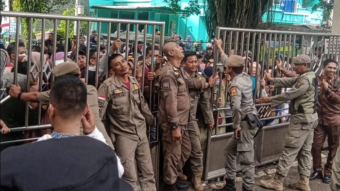 Warga berebutan masuk ke halaman Setda Kabupaten Sukabumi untuk mendapatkan beras murah.