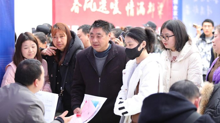 CHONGQING, CHINA - FEBRUARY 19, 2024 - Job seekers consult job information in front of a company's recruitment booth at a job fair in Chongqing, China, February 19, 2024. (Photo credit should read CFOTO/Future Publishing via Getty Images)
