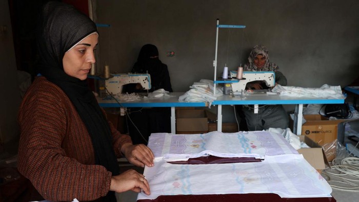 Palestinians sew diapers in a workshop amid scarcity as the conflict between Israel and Hamas continues, in Rafah in the southern Gaza Strip, February 19, 2024. REUTERS/Ibraheem Abu Mustafa