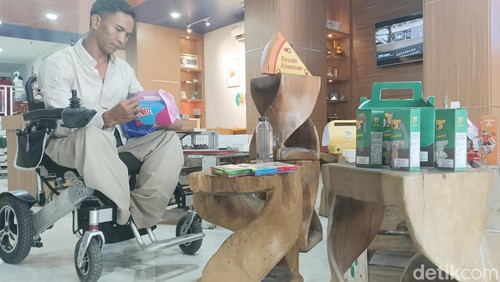 Peserta pelatihan UMKM difabel sekaligus pemilik Stika Aksesoris I Ketut Suartika saat memperhatikan kemasan produk di salah satu kampus di Denpasar, Selasa (20/2/2024). (Ni Made Lastri Karsiani Putri)