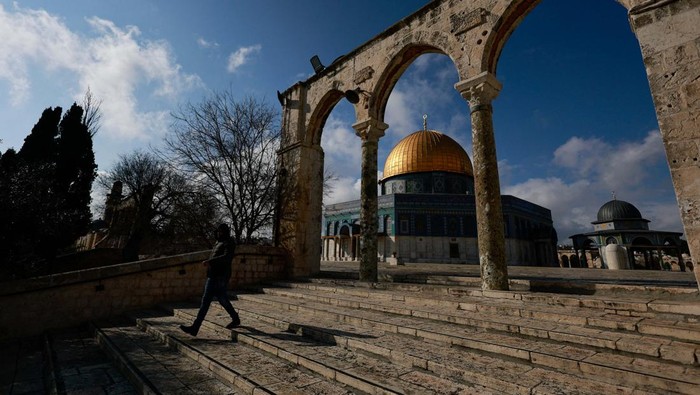 A Palestinian walks in front of the Dome of the Rock on Al-Aqsa compound, also known to Jews as the Temple Mount, in Jerusalems Old City, February 19, 2024. REUTERS/Ammar Awad