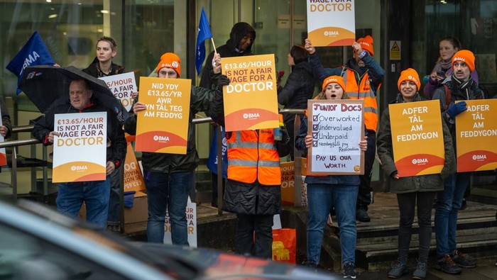CARDIFF, WALES - FEBRUARY 21: Doctors and supporters gather at the University Hospital of Wales at the beginning of a 72-hour strike on February 21, 2024 in Cardiff, United Kingdom. The strike reflects a prolonged dispute with the Welsh Government, protesting a reported nearly one-third drop in doctors' salaries over 15 years, as indicated by the British Medical Association (BMA). (Photo by Matthew Horwood/Getty Images)