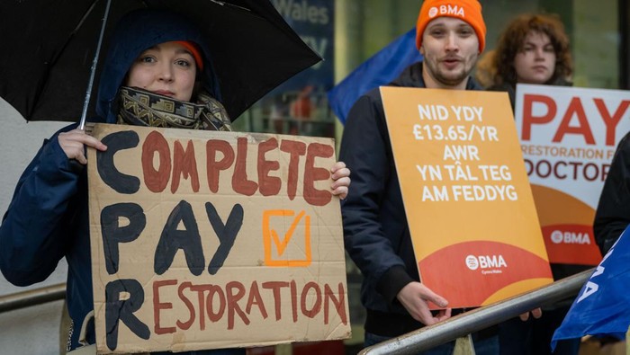 CARDIFF, WALES - FEBRUARY 21: Doctors and supporters gather at the University Hospital of Wales at the beginning of a 72-hour strike on February 21, 2024 in Cardiff, United Kingdom. The strike reflects a prolonged dispute with the Welsh Government, protesting a reported nearly one-third drop in doctors' salaries over 15 years, as indicated by the British Medical Association (BMA). (Photo by Matthew Horwood/Getty Images)