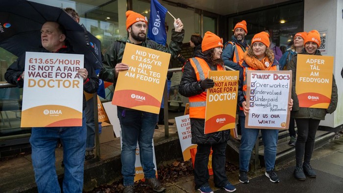 CARDIFF, WALES - FEBRUARY 21: Doctors and supporters gather at the University Hospital of Wales at the beginning of a 72-hour strike on February 21, 2024 in Cardiff, United Kingdom. The strike reflects a prolonged dispute with the Welsh Government, protesting a reported nearly one-third drop in doctors' salaries over 15 years, as indicated by the British Medical Association (BMA). (Photo by Matthew Horwood/Getty Images)