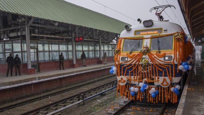 Security men react to camera as they stand inside the first electric train in the Kashmir valley on the outskirts of Srinagar, Indian controlled Kashmir, Tuesday, Feb. 20, 2024. Prime Minister Narendra Modi on Tuesday virtually flagged off the train service between Sangaldan station and Baramulla station during a public rally in Jammu. (AP Photo/Dar Yasin)