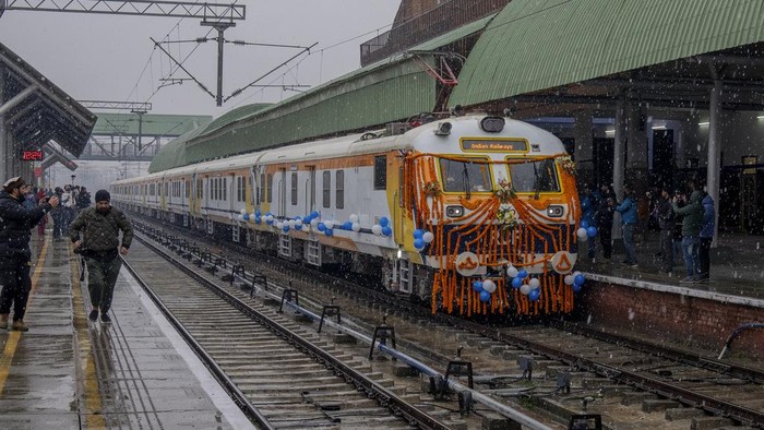 Security men react to camera as they stand inside the first electric train in the Kashmir valley on the outskirts of Srinagar, Indian controlled Kashmir, Tuesday, Feb. 20, 2024. Prime Minister Narendra Modi on Tuesday virtually flagged off the train service between Sangaldan station and Baramulla station during a public rally in Jammu. (AP Photo/Dar Yasin)