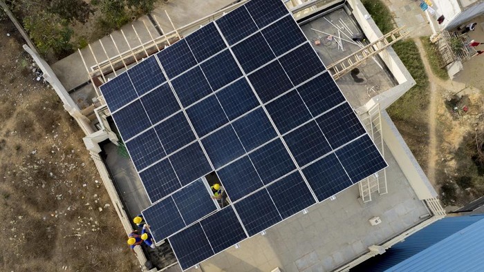 Workers of Solar Square put up a panel on the rooftop of a residence in Gurugram on the outskirts of New Delhi, India, Tuesday, Feb. 20, 2024. India is renewing its push to add rooftop solar to meet the needs of a fast-growing nation that's hungry for energy. (AP Photo/Manish Swarup)