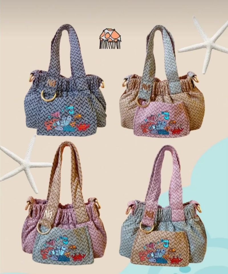 Dumpling bag (tas tangan perempuan) produksi Misis Devi yang dihiasi bordir lukisan biota laut karya anak autistik, Malik