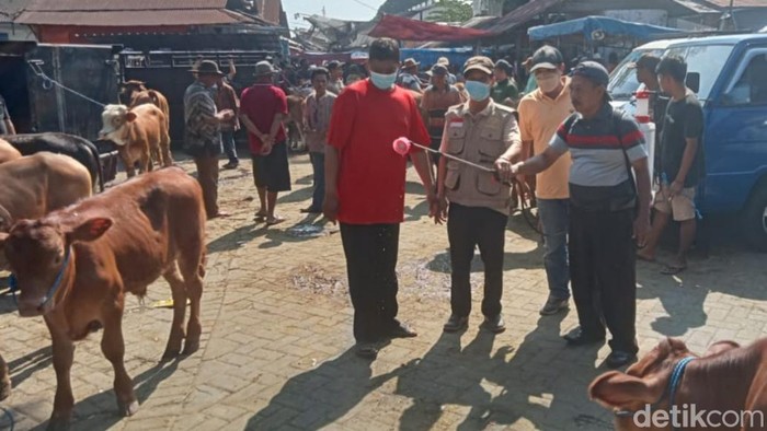 Penyemprotan desinfektan di salah satu pasar hewan di Pasuruan.