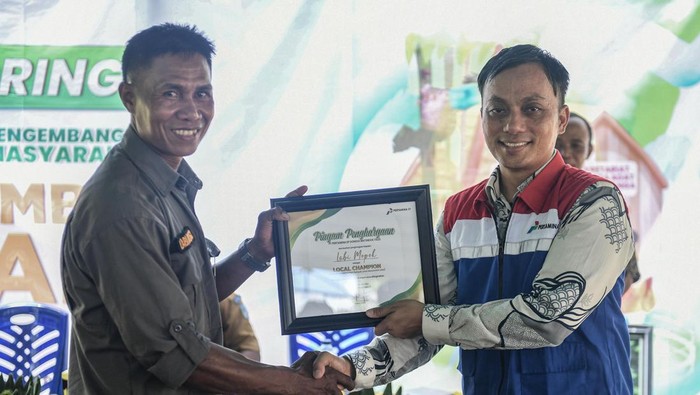 Berdaya dan mandiri dalam Kokolomboi Lestari Field Manager Pertamina EP Donggi Matindok Field Ridwan Kiay Demak (kanan) memberikan penghargaan sebagai local champion kepada Pengelola Taman Kehati Kokolomboi, Labi Mopok.