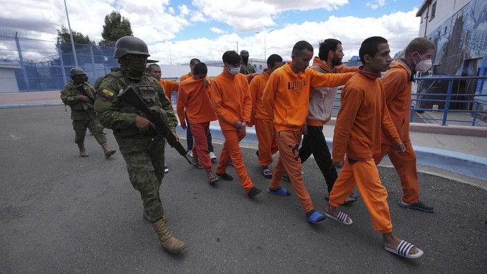 Soldiers escort inmates at the Cotopaxi prison during a press tour organized by the military, in Latacunga, Ecuador, Thursday, Feb. 22, 2024. According to the military, the tour is to demonstrate that control has been regained inside the prisons cross the country. (AP Photo/Dolores Ochoa)
