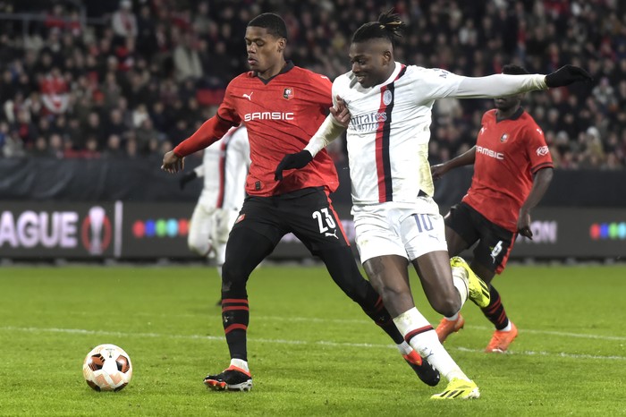 AC Milans Rafael Leao, right, and Rennes Warmed Omari fight for the ball during the Europa League soccer match between Rennes and AC Milan at the Roazhon Park stadium in Rennes, western France, Thursday, Feb. 22, 2024. (AP Photo/Mathieu Pattier)