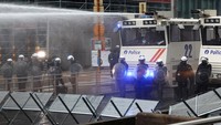 Polisi yang bersiaga membuat barikade dan meriam air untuk menghalau massa.