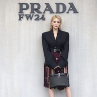 Jeon Somi yang viral disebut ‘Barbie hidup’ dengan rambut pirang dan wajah blasteran, mewakili Prada. Dia mengenakan setelan jas hitam dan rok berwarna burgundy dengan aksen rumbai-rumbai, yang mempertegas pinggang semutnya. Foto: Instagram