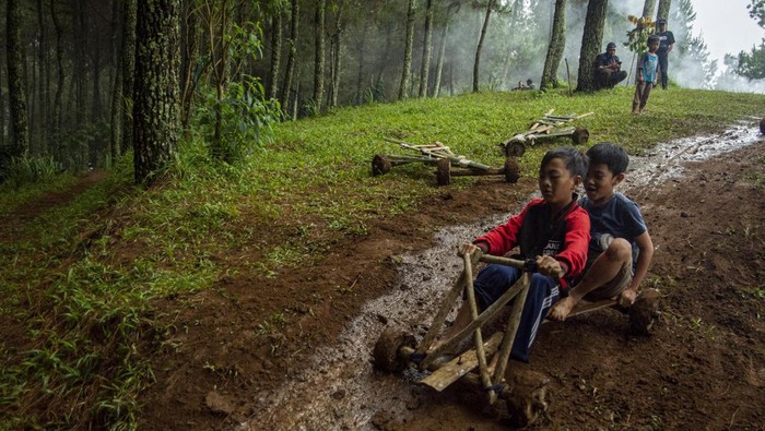 Warga membawa alat bermain tradisional Kadaplak di Kampung Pasir Angling, Kabupaten Bandung Barat, Senin (26/2/2024). Kadaplak yang pada zaman Belanda sempat dimanfaatkan untuk mengangkut hasil tani dan tembakau tersebut kembali dihadirkan masyarakat kampung Pasir Angling guna mengenalkan dan mengedukasi agar permainan tradisional itu tetap lestari di tengah perkembangan teknologi. ANTARA FOTO/Novrian Arbi/Spt.