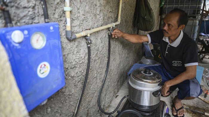 Bye LPG, Peternak Ini Manfaatkan Kotoran Sapi Jadi Biogas buat Masak Seorang peternak memeriksa tangki biogas yang berasal dari limbah kotoran sapi di Jakarta, Selasa (27/22024). Sebanyak tujuh rumah warga di sekitar peternakan sapi tersebut memanfaatkan limbah kotoran ternak untuk menjadi energi biogas dalam kehidupan sehari-hari. ANTARA FOTO/Erlangga Bregas Prakoso/rwa.